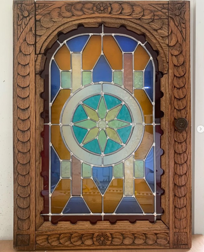 Klassiek glas-in-lood raam met geometrische vormen en zachte kleuren